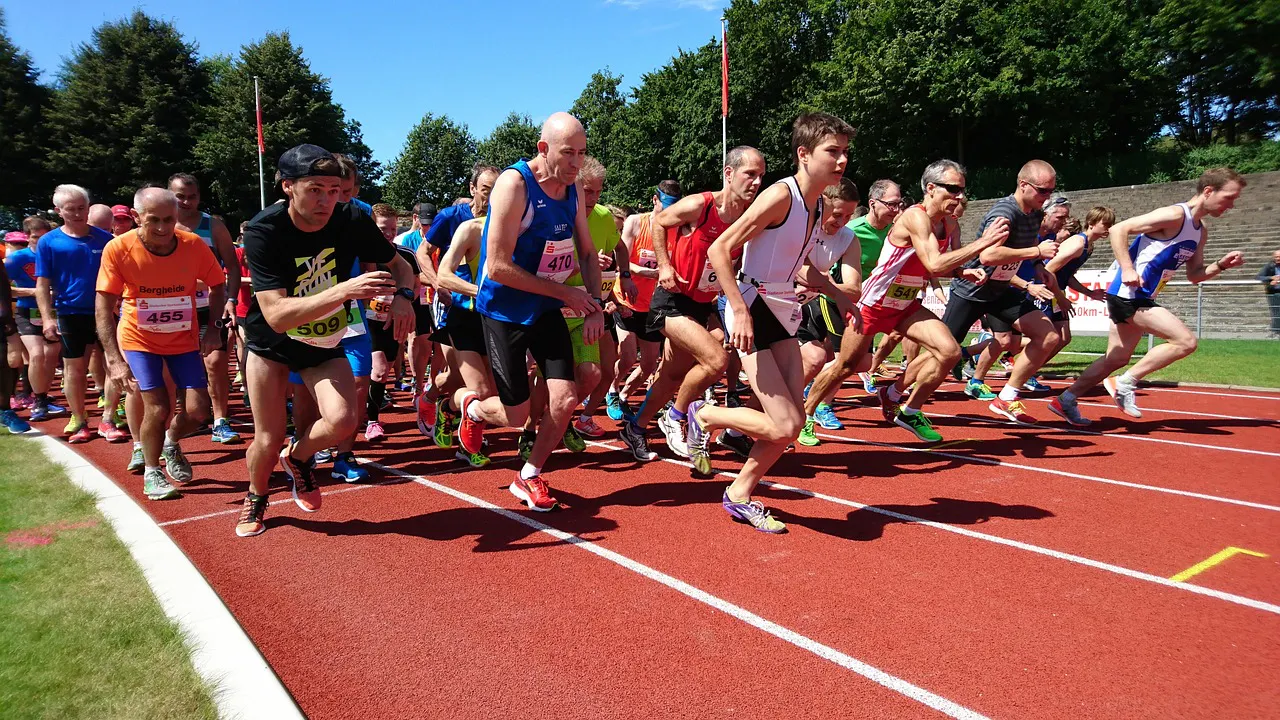 Group of runners starting their race on an outdoor track