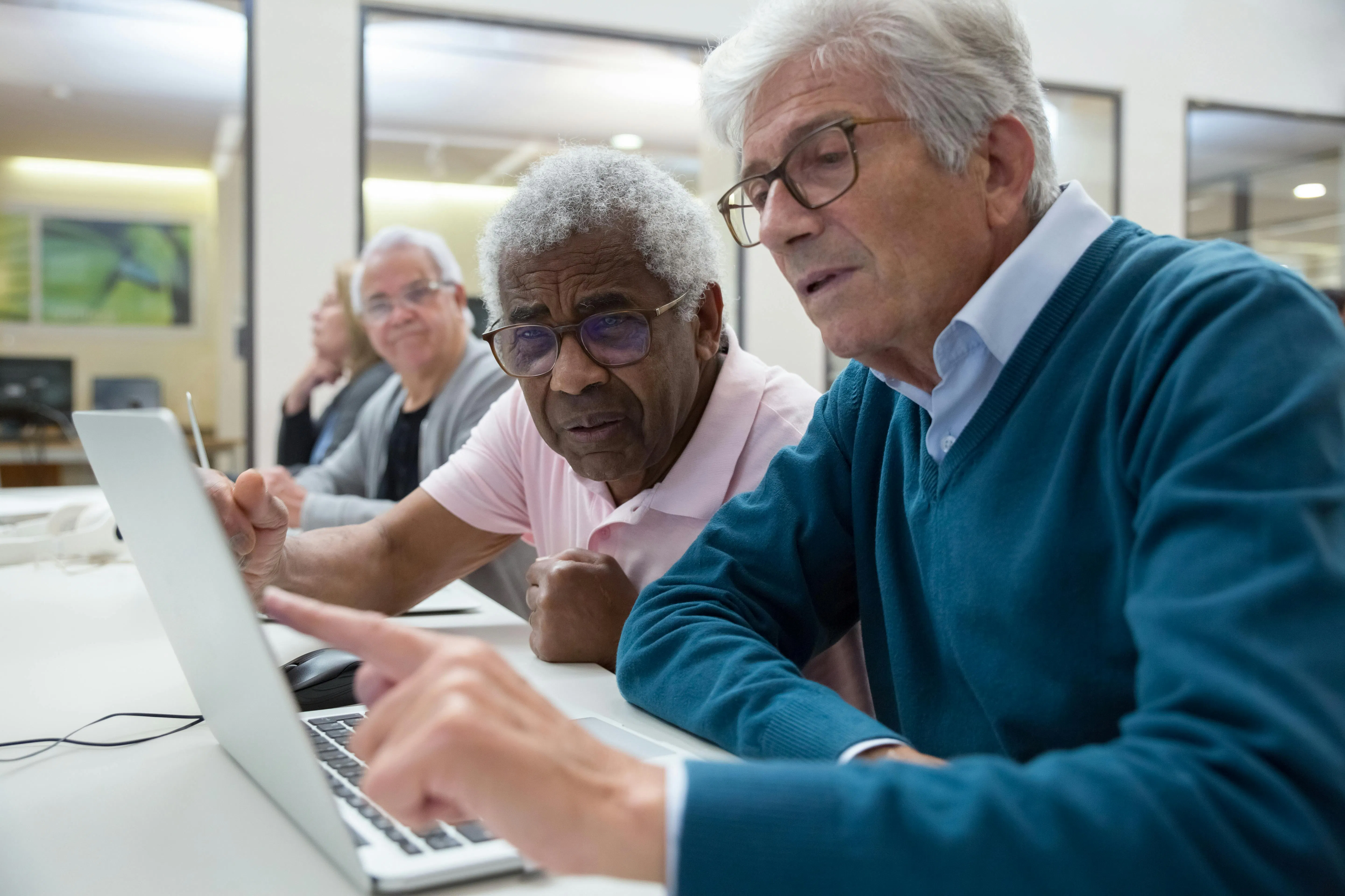 Men using a laptop in class