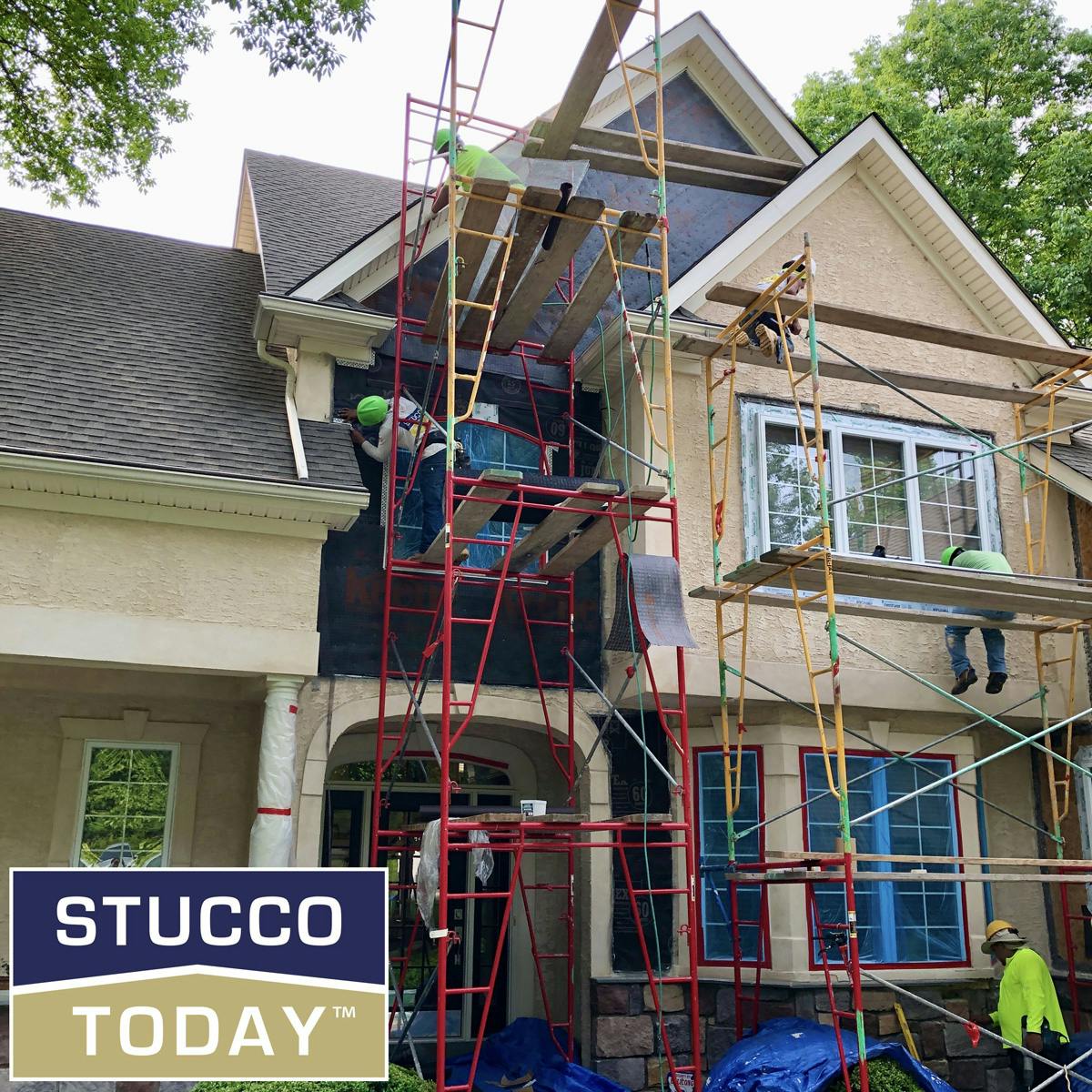 large suburban house with stucco remediation in progress