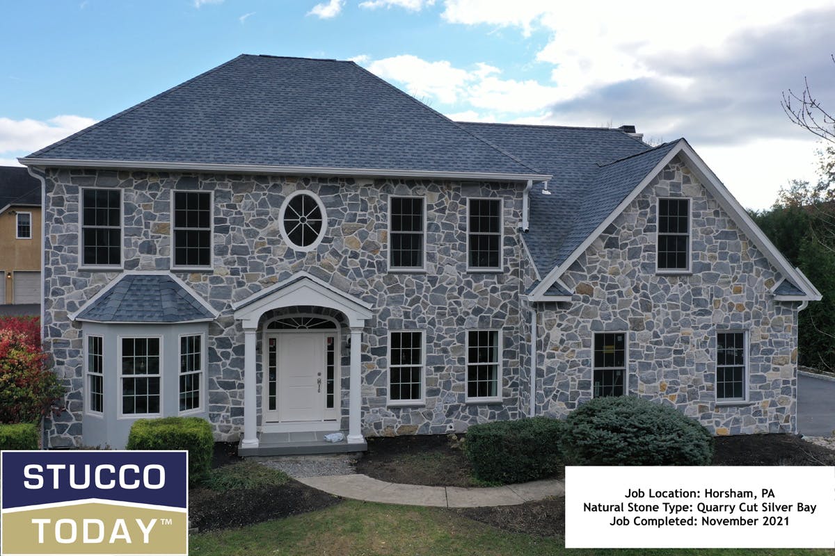 large suburban house with stucco remediation completed