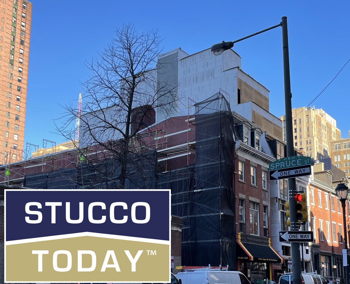 large suburban house with stucco remediation in progress