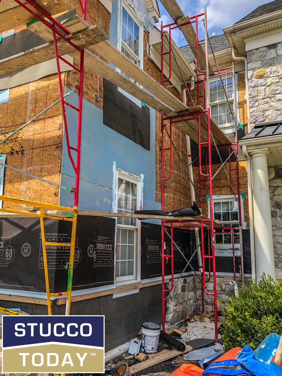 large suburban house with stucco remediation in in progress