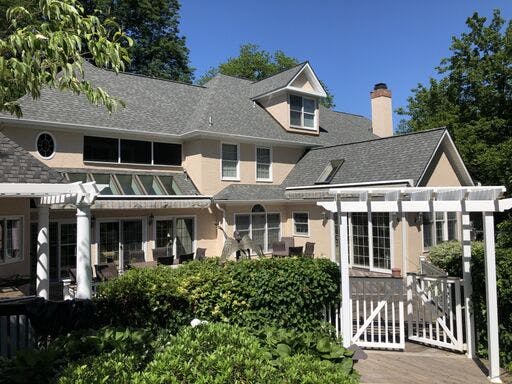 white suburban house with completed stucco remediation