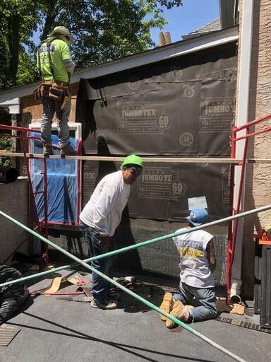 a group of workers for stucco remediation for suburban house in pa