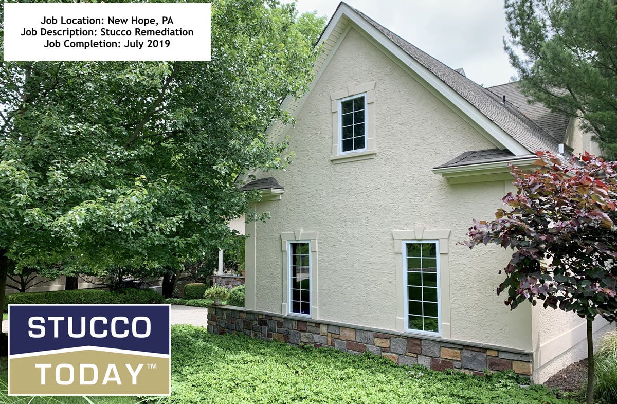 large suburban house with stucco remediation in progress