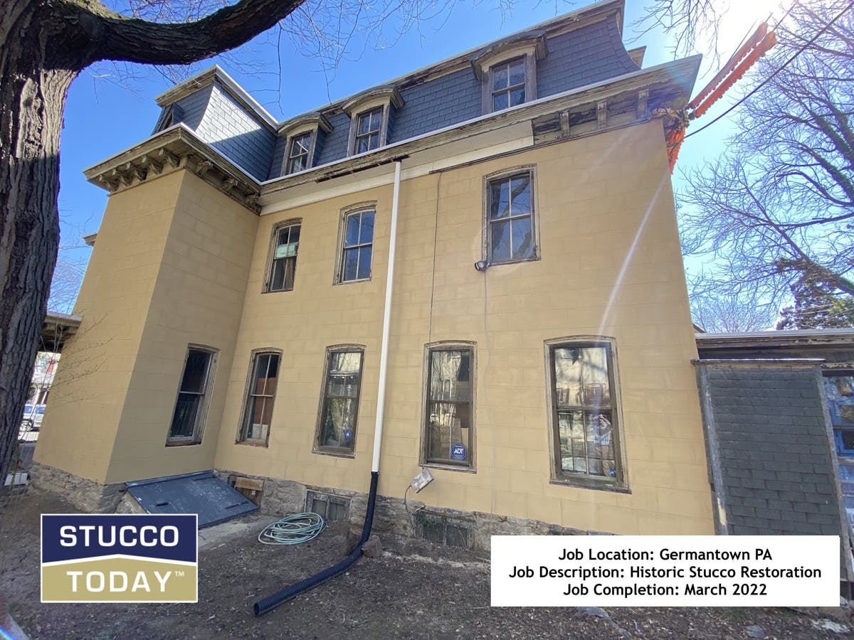 large suburban house with stucco remediation in progress