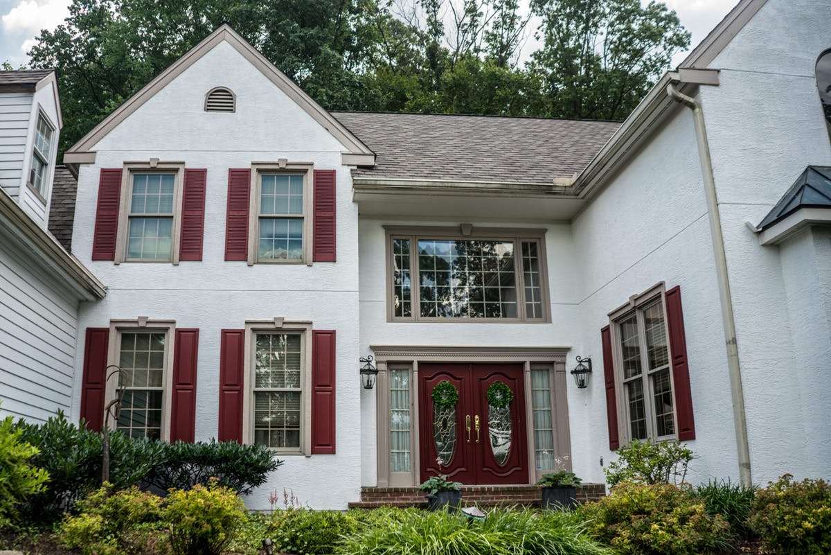 two story suburban house with completed stucco remediation