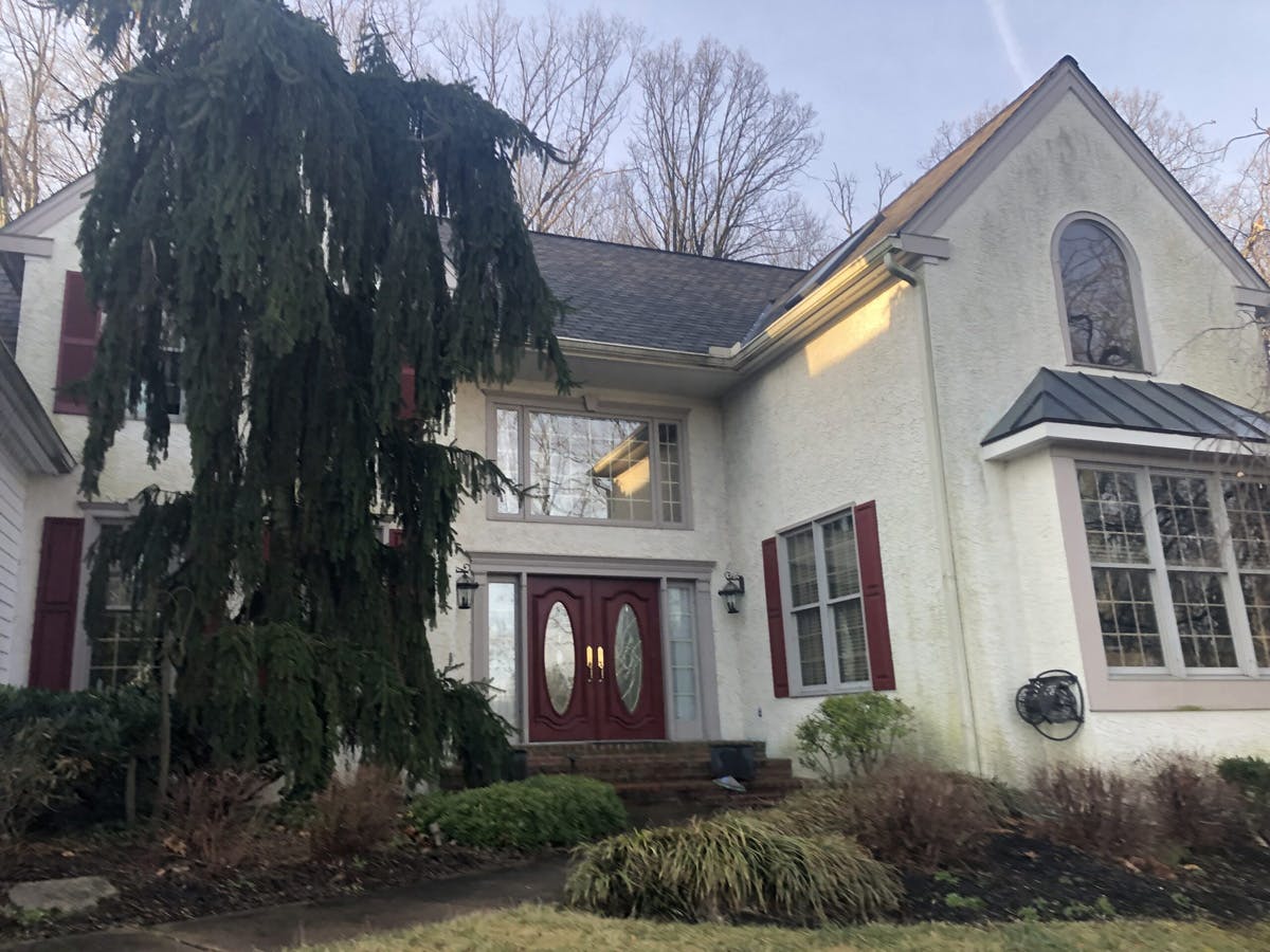 two story suburban house with completed stucco remediation