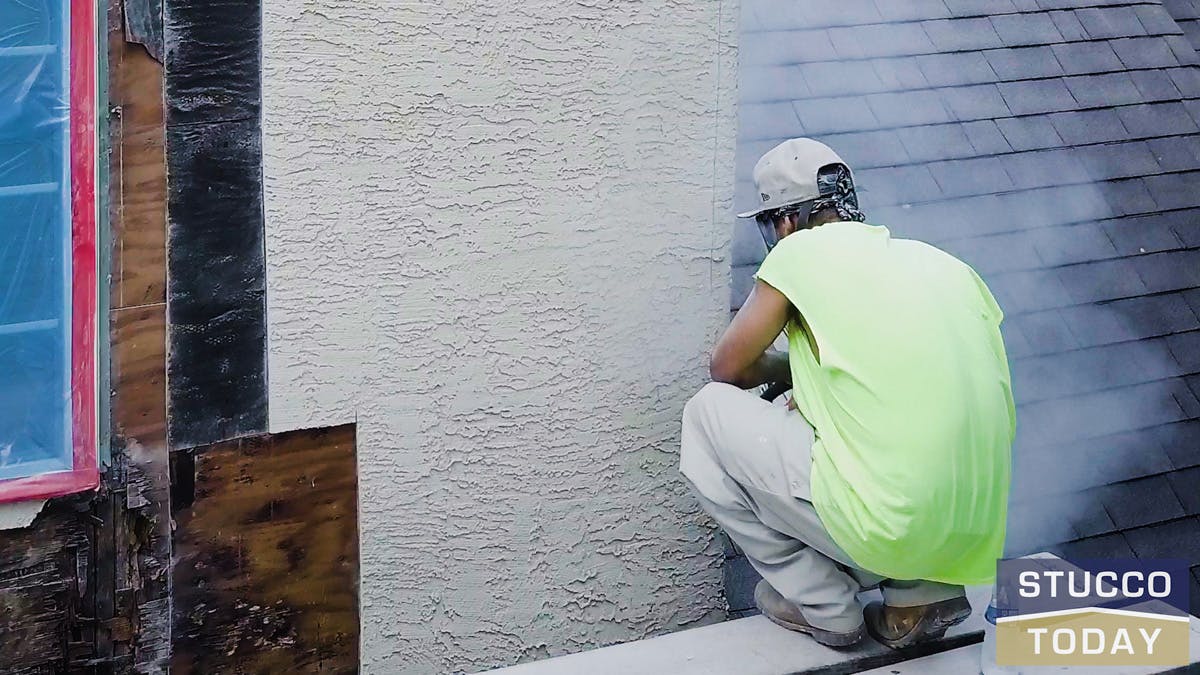 a guy working on stucco remediation for suburban house in west chester, pa