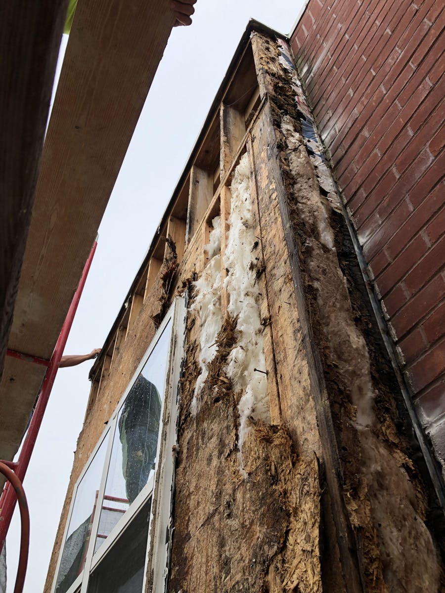 two story suburban house with in progress stucco remediation