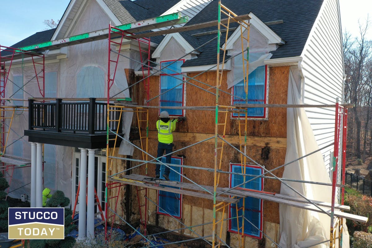 suburban house with stucco remediation in progress