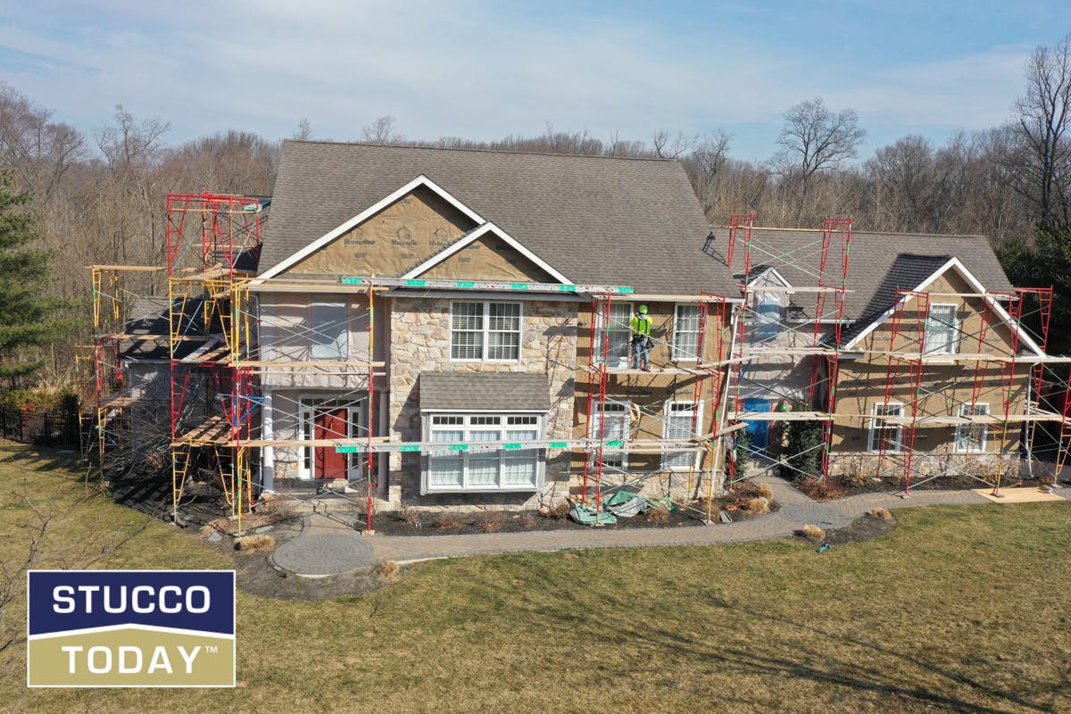 suburban house with stucco remediation in progress