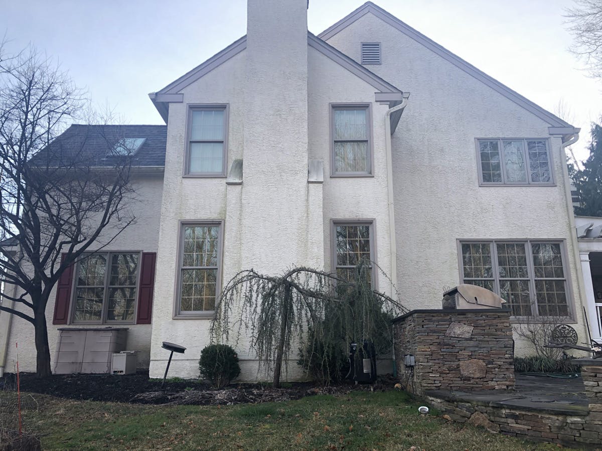 two story suburban house with completed stucco remediation