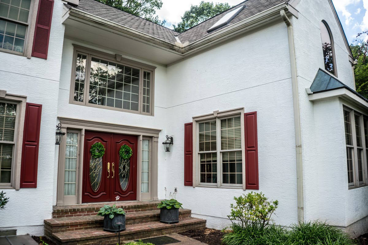 two story suburban house with completed stucco remediation