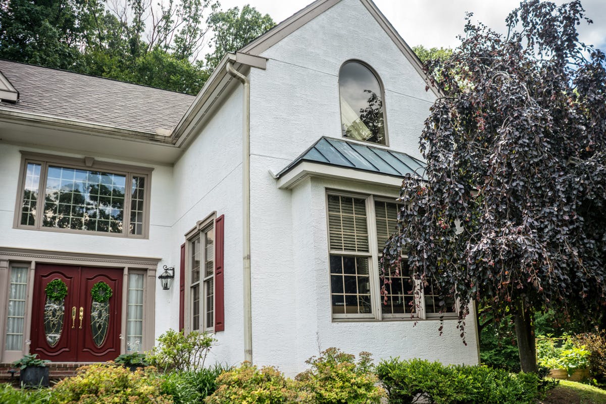 two story suburban house with completed stucco remediation