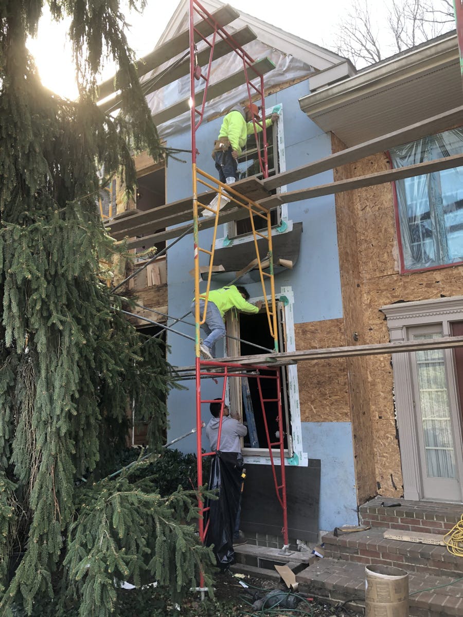 two story suburban house with in progress stucco remediation